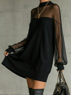Vestido mini negro con mangas de malla transparente y cuello alto